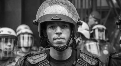 Close-up grayscale portrait of a riot police officer in Sao Paulo, Brazil.